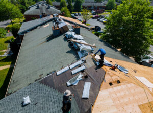 Roofing workers installing new roof within budget