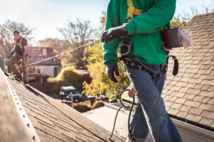 worker performing roof inspection for roofing insurance claims